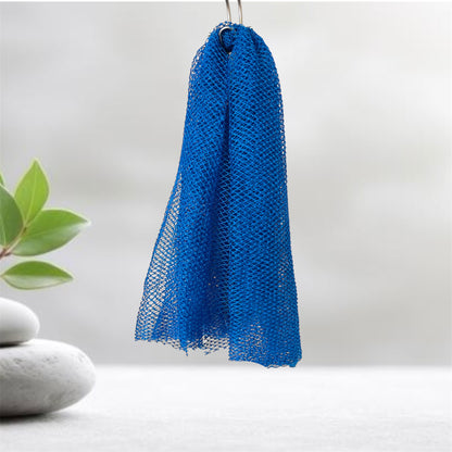Blue mesh scrubber hanging on a hook with a plant and stones in the background
